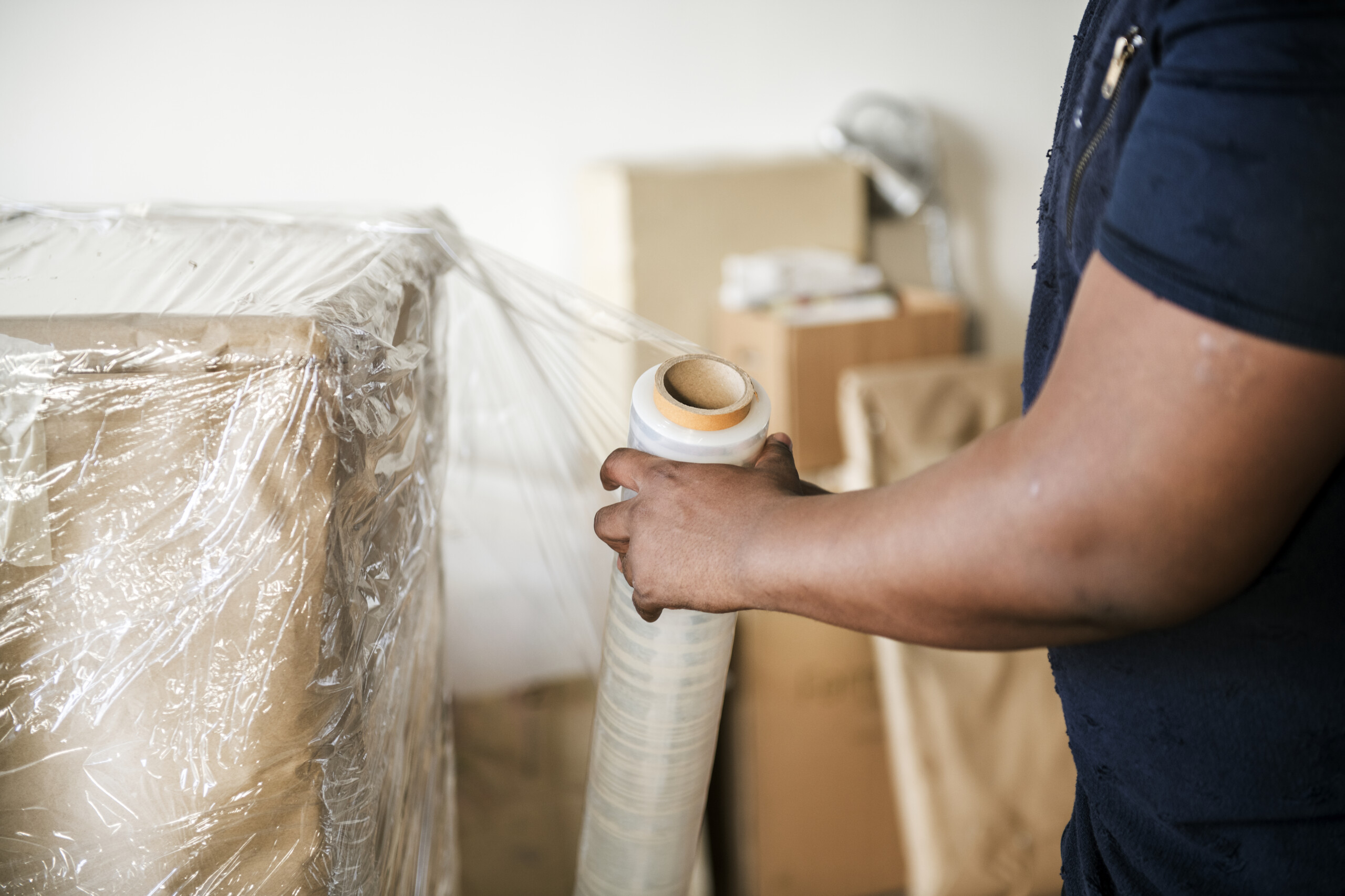 Black man moving furniture black-man-moving-furniture-scaled.jpg